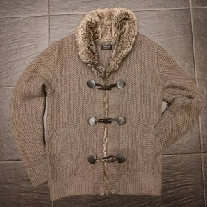 Pälsfodrad cardigan  - Säljer en mysig pälsfodrad cardigan. Fint skick utan defekter.Cardiganen har en tjock fin pälskrage och stilren design. Skriv vid minsta fundering!