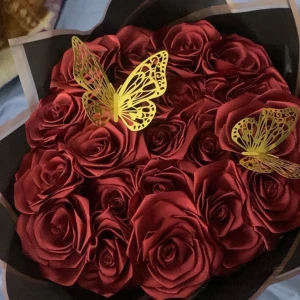 Röda satin rosor  - Säljer denna bukett med satin rosor då jag tidigare hade ett litet företag. Dessa rosor är 100% handgjorda, mer vinröd i mörkret. Det är va 20 rosor samt 2 guld fjärilar med ett svart omslagspapper. Obs pris går att diskutera!