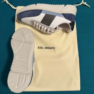 Axel Arigato Genesis vintage - Blåvit  - Snygga sneakers från Axel Arigato i en stilren design. Skick: 9/10. Storlek: 41. Pris: 1400kr. Nypris: 2500kr. Vid minsta funderingar, tveka inte att skriva!