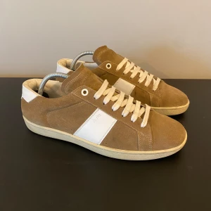 Saint Laurent skor - Tja säljer nu dessa riktigt feta saint Laurent ”SL/02” skorna! Skorna görs ej längre! Skorna är i fint skick! Skorna är i storlek 39 men sitter som 40, innersulans mått är 26,5 cm! Skriv vid frågor eller bilder! Snabbaffär=bättre pris! Sugen? Skriv så löser vi en bra deal🤝