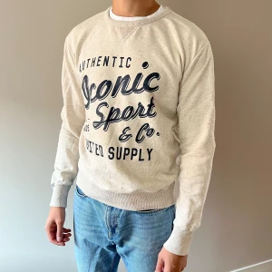 Sweatshirt med tryck - En offwhite sweatshirt med mörkblått tryck. Väl använd men i fint skick. 