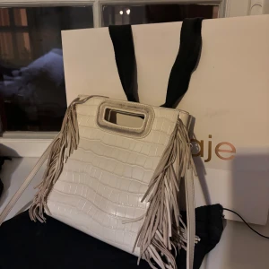 Maje m bag crocodile- effect leather i vanilla ecru - Säljer min maje väska som man kan se är bräken avskrapas från handtaget men det är typ det ända felet med väskan o Derför säljs den så billig. Dustbag finns och pris kan diskuteras. Originalpris var ca 3500 ❤️