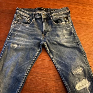Replay - Snygga blå jeans från Replay med slitna detaljer och dragkedja. Perfekta för att klä upp sig lite snyggare, nypris runt 1800 vårat pris 399