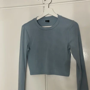 Ljusblå croppad tröja från Gina Tricot - Säljer en stilren ljusblå croppad tröja från Gina Tricot. Tröjan är super mjuk den är använd bara 2 gånger super gulligt färg 💙☺️✨
