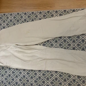 Beige linne byxor - Mid waist och rak passform, finns en liten fläck, passar även 36