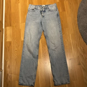 Mid waist jeans - Säljer mina mid waist jeans från zara som inte kommit till användning så mycket de senaste. Jeansen är gjorda med slitningar vid midjan, fickorna och längst ner vid benen. Inga tecken på andvändning och jeansen stängs med hjälp utav knappar. St 36
