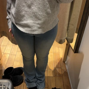 Blå bootcut jeans - Snygga blå bootcut jeans från true religion med en klassisk femficksdesign. Jeansen har en bekväm passform och är perfekta för en avslappnad stil. De är tillverkade i ett mjukt och stretchigt material som ger en skön känsla hela dagen. Är uppsydda 7 cm så passar perfekt i längden ( är 156) är i storlek 40 och där är förstora i midjan på mig.