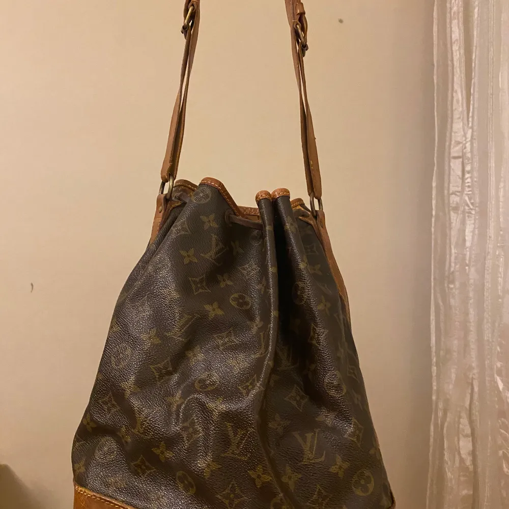 Säljer en klassisk Louis Vuitton axelväska med monogrammönster i modellen Noé. Den är i acceptabelt skick med synligt slitage på kanterna i botten som har blivit med åldern. Men den är fortfarande stilren och rymlig. Insidan är fräsch och ren. Kvitto från Luxe Porter finns. Fler bilder/filmklipp går att få. Pris går att diskutera vid snabb och smidig affär. . Väskor.