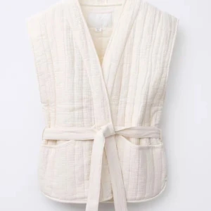 Vit quiltad väst med knytband - Säljer en stilren vit/beige quiltad väst med knytband i midjan och två fickor framtill. Västen är as cool och passar nästan till allt!! Köpt för 359kr och säljer för 250❤️ Aldirg använd endast prövad!! Tryck på köp nu och du inte har några frågor❤️😊