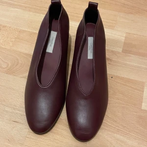 Vinröda pumps med blockklack - Snygga vinröda pumps från CelebShop i äkta läder. Storlek 37 med 5cm klack. Har använt de några få gånger. 