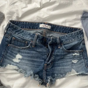 Blå lågmidja jeansshorts från Hollister - Säljer ett par snygga blå jeansshorts från Hollister. Storlek w26 eller xs/s!