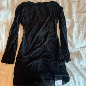 Glittrig kort klänning  - Säljer denna fina glittriga Korta långärmada klänning som aldrig är använd 