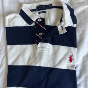 Randig ralphlauren pique  - Hej! Säljer denna piké för att den är för slim på min kropp, fick den av min morbror för att han tömde sin garderob och väljer att sälja vidare, storlek m slim fit och den är i bra kvalitet fortfarande 😍