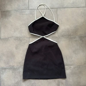 Svart cut out kortklänning med vita band från zara - Supersnygg svart kortklänning med vita kontrastband och trendig cut out-design i midjan från zara💗 aldrig använd 