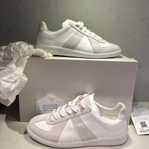 Helvita Maison margiela gata  - 👋Hola• Säljer dessa spriten nya sjuka snygga helvita gatsen från maison margiela• Storlek 40 men passar 41• Allt og kommer med såsom box,dustbag,kort med verifiering och qr kod vid sidan av boxen, NFC finns även under skon på märket 22• Skick 10/10• Pris 3400kr, kan sänka vid snabb affär• kom pm för fler bilder osv• Caio 👋