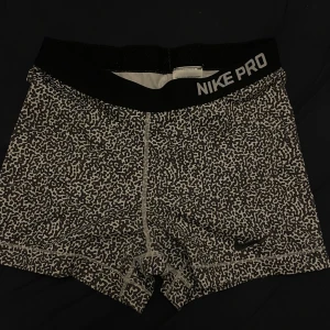 Mönstrade träningsshorts från Nike - Snygga och bekväma träningsshorts från Nike Pro med ett unikt mönster i svart och grått. Perfekta för intensiva träningspass med en elastisk midja för extra komfort.