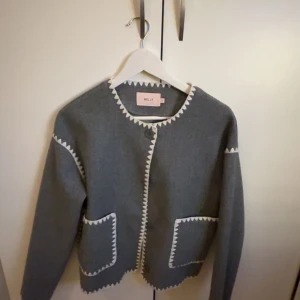 Grå kavaj från Nelly - Jätte fin grå kappa med detaljer på från Nelly.