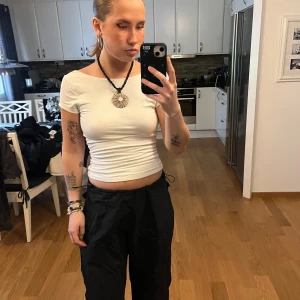 Svarta parachute byxor från pull and bear  - Trendinga svarta parachute byxor från pull and bear. Storlek M