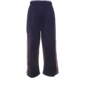 Mörkblå träningsbyxor från Tommy Sport - Snygga mörkblå träningsbyxor från Tommy Sport med ränder i rött och vitt längs sidorna. Byxorna har en bekväm passform och elastisk midja, perfekta för sport och fritid. Straight/Loose. Storlek S/M