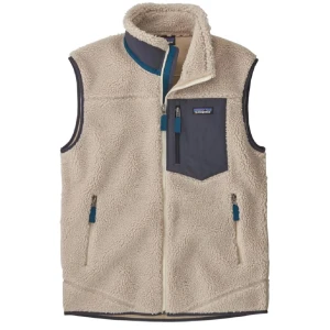 Beige fleeceväst från Patagonia - Mysig beige fleeceväst från Patagonia med dragkedja framtill och tre fickor med dragkedja. Bröstficka i grått tyg och blå detaljer vid dragkedjorna. Perfekt lager för kyliga dagar.