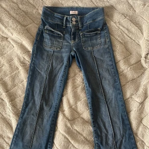 Blå bootcut jeans från NLY - Säljer ett par jättesnygga jeans ifrån Nelly💗Jättesnygga blåa jeans med fickdetaljer fram. De är lågmidjade och bootcut. Storlek 34💗💗
