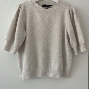 Beige stickad tröja Vero Moda M - Säljer en beige stickad tröja från Vero Moda i storlek M. Tröjan har puffade trekvartsärmar och ribbade muddar vid hals, ärmslut och nederkant. Mjuk och skön struktur som ger en chill vibe. Perfekt för lager-på-lager under hösten och vintern.