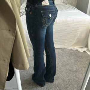 True Religion Joey Low Rise Flare Jeans - Säljer ett par mörkblå True Religion Joey jeans med låg midja och flare-ben. Använda enstaka gånger, innerbenslängd är 81cm💖🥰