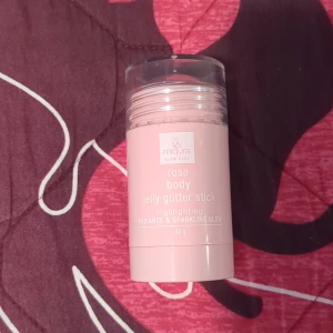 Body glitter stick - Miqura Glow Care rose body jelly glitter stick, en highlighter i stickform med rosaskimrande glitterfinish. Ger en strålande och glittrig glow till huden. Kommer i en praktisk rosa plastförpackning med transparent lock, 30 g. Säljer den för att dne irriterade min hy☺️ (Har fortfarande plastgrejen på)
