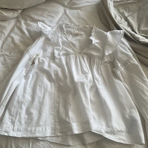 vit blus - säljer denna gulliga blusen den har fläckar som inte går bort, den 2 bilden är smink och 3 är målarfärg, men de syns inte när man har på sig den eftersom att färgen är på insidan av armen!!