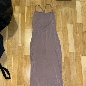 långklänning Shein - Säljer en stilren brun långklänning från Shein. Klänningen har smala axelband och en figurnära passform som ger en elegant look. Perfekt för en kväll ute eller en speciell tillställning. Hör av dig vid intresse!