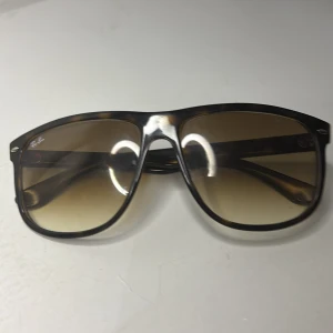 Ray-Ban boyfriend, bruna solglasögon i pilotstil - Snygga Ray-Ban boyfriend. solglasögon med brunmelerad båge och klassisk pilotform. Glasen är tonade i brunt och bågarna har Ray-Ban-logga på sidan. Perfekt accessoar för en cool look och passar till de flesta outfits.