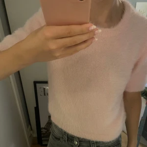 Ljusrosa stickad tröja  - Supermjuk och fluffig ljusrosa stickad tröja från Pieces. Tröjan har korta ärmar och rund halsringning, perfekt för dig som gillar en söt och enkel stil. Passar snyggt till både jeans och kjol. Andvänt fåtal gånger💕