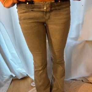 Grå bootcut jeans från Perfect Pants - Snygga grå jeans från Gina tricot med bootcut passform och klassiska femficksdetaljer. Jeansen är midwaist och är tillverkade i mjukt bomullsmaterial med lite stretch för extra komfort. Perfekta för dig som gillar en stilren och trendig look.