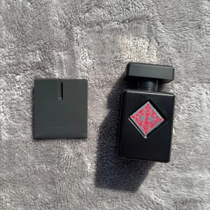 Initio Absolute Aphrodisiac  - Säljer en exklusiv parfym från Initio, Absolute Aphrodisiac. Flaskan är elegant svart med en röd dekorativ detalj i mitten. Parfymen kommer i en stilren svart kartong med matchande röd design. Flaskan rymmer 90 ml av denna förföriska doft.Vid eventuella frågor är det bara att höra av er. Kvitto tillkommer.