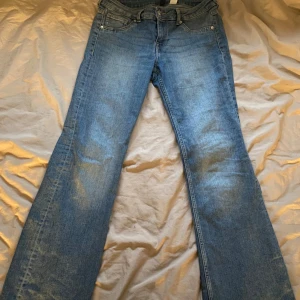 Lågmidjade jeans  - Säljer ett par klassiska blå jeansbyxor med bootcut-stil. De har en normal passform och är tillverkade i jeansmaterial. Perfekta för en avslappnad look. Dom är lågmidjade, jag är 174 och dom passar perfekt i långd. Dom är storlek 42 men passar 40/38. Har ett par i svart, samma storlek och allt! 