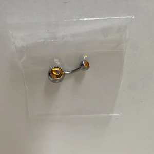Titanium Piercingsmycke med gul sten - Snyggt titanium piercingsmycke i silverfärg❤️