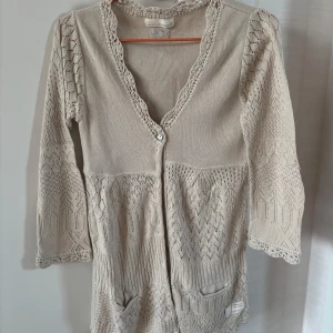 Beige kofta från Odd Molly med spets - Supersöt beige kofta från Odd Molly i storlek S med virkade spetsdetaljer och mönstrad stickning. Fint skick!🤍