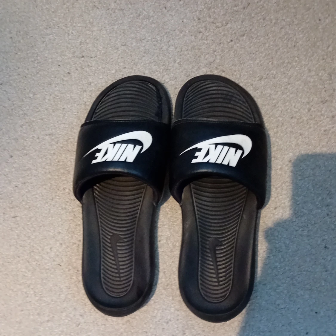 Svarta Nike sandaler med vit logga