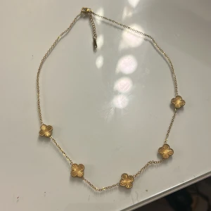 Guldigt halsband med blommor - Snyggt halsband helt nytt 