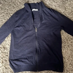 Mörkblå kofta från Selected Homme - Mörkblå kofta från Selected Homme med hel dragkedja framtill och ribbade muddar vid ärmslut och nederkant. Tröjan är i storlek S🤩🙌
