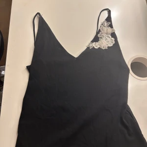 Svart linne med blommig spetsdetalj - Jätte gulligt linne som jag själv tycker är one size även fast de står L, passar mig som bär S💕💕🩷🩷 Står L (large)