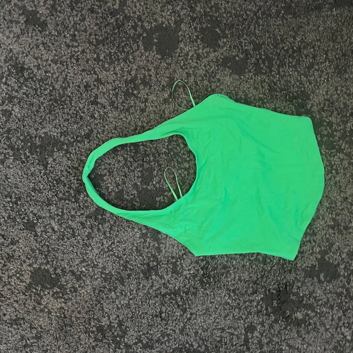 Grön ärmlös linnetopp