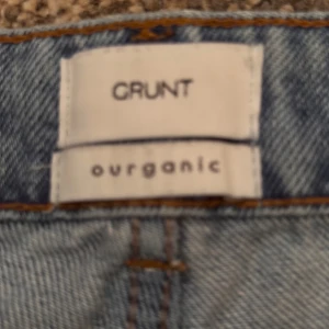Ljusblå jeans från Grunt - Säljer ett par ljusblå jeans från Grunt med klassisk femficksdesign och raka ben. Jeansen har en enkel look utan slitningar och är tillverkade i ett mjukt denimtyg. Perfekta för dig som gillar en stilren och avslappnad stil. Storlek 152