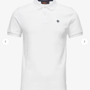 Vit pikétröja från Morris - Klassisk vit pikétröja från Morris andvänd 1 gång med korta ärmar och krage. Tröjan har två knappar framtill och en liten broderad logga på bröstet. Tillverkad i mjuk bomull som känns skön mot huden. Perfekt för en clean och stilren look. Kontakta för mer bilder eller funderingar! Storlek M men passar stor S