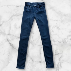 Mörkblå slim jeans från Replay W28 L32 - Snygga mörkblå jeans från Replay med slim passform. Klassisk femficksmodell med knapp och dragkedja framtill. Jeansen har en stilren look och är tillverkade i ett stretchigt material för extra komfort. Modell: New Luz