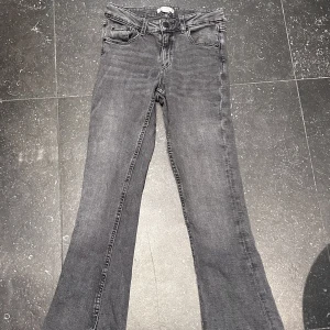 Jeans - Säljer mina mörktgråa lågmidjade Bootcut jeans från Gina tricot. De är i storlek 152. Har sytt lite vid ena bakfickan men synd inte när man har dom på (se sista bild) därav priset. Hör av er vid frågor. Köparen står för frakten!