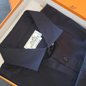Brand new Hermes shirt size M/39 in dark midnight blue. With the original orange box and Hermes paper bag.