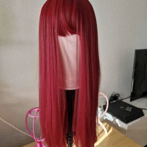 Röd peruk - Superfin syntetisk peruk. Finns spännen på insidan. Kan fraktas 