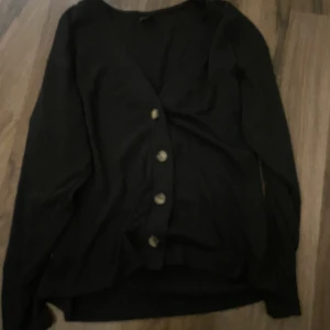 Svart knapp kofta - Svart v ringad kofta med bruna knappar