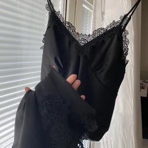 Slip-on klänning - Svart slip-on i silke med spetsdetaöjer, köpt second hand i USA men hittar inga defekter, tyvärr för stor på mig, hör av dig för mer info/bilder